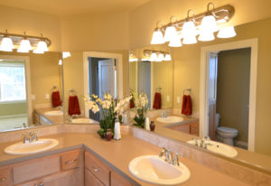 Bathroom renovation with 2 sinks separated by corner.