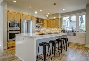 Kitchen design welcomes the family into the space with beautiful double duty island.