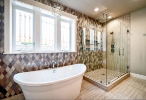 Bathroom renovation with tiled wall, independent shower and traditional free standing bath.