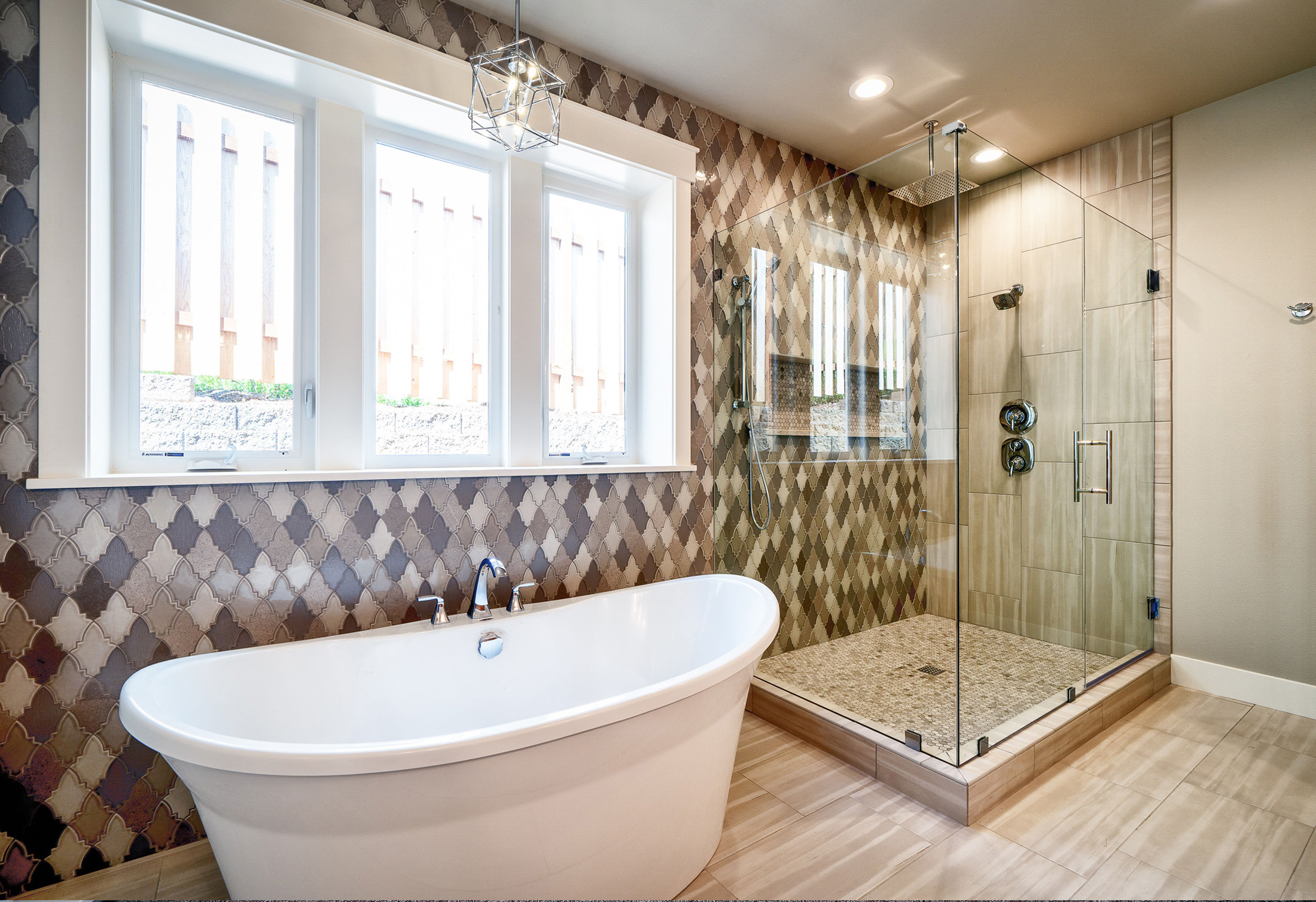 Bathroom renovation with tiled wall, independent shower and traditional free standing bath.